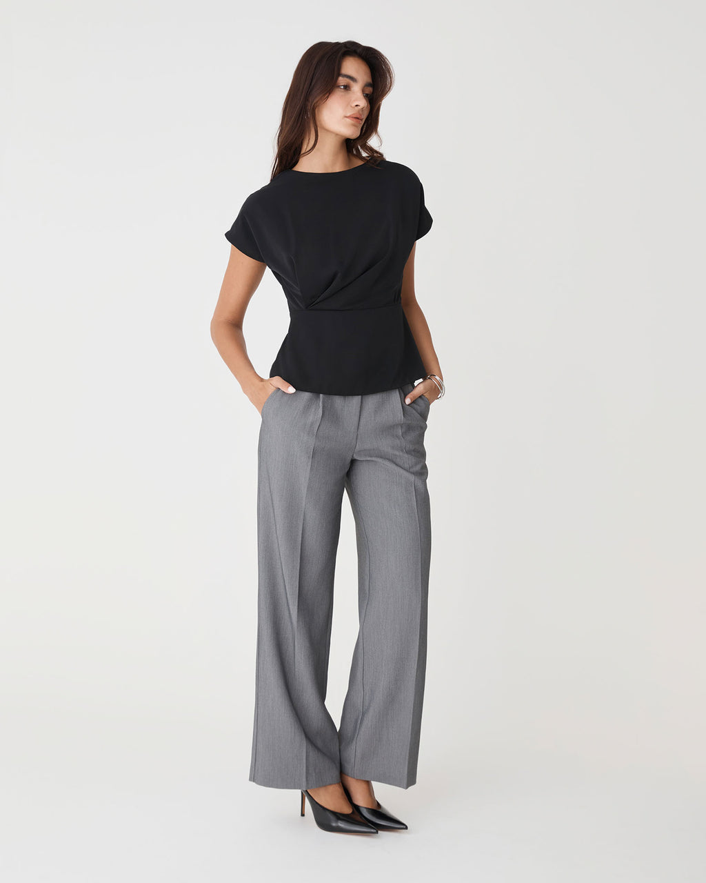 Bonnie Gathered Peplum Top in black — full-length view