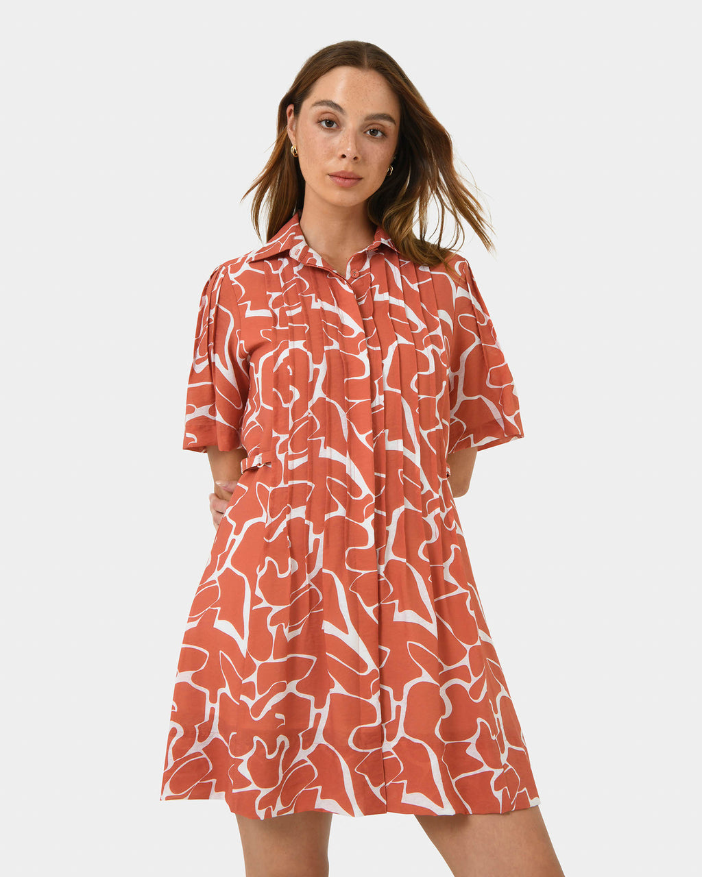 Sunshine Pleated Dress in coral print — close-up view