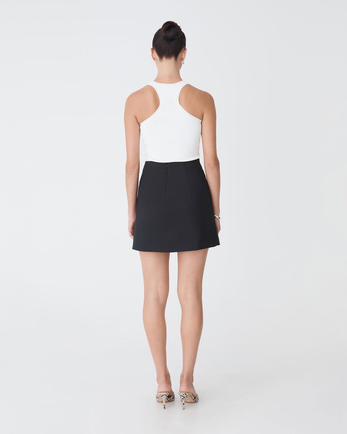 Aaria Asymmetric Skirt in black — back view