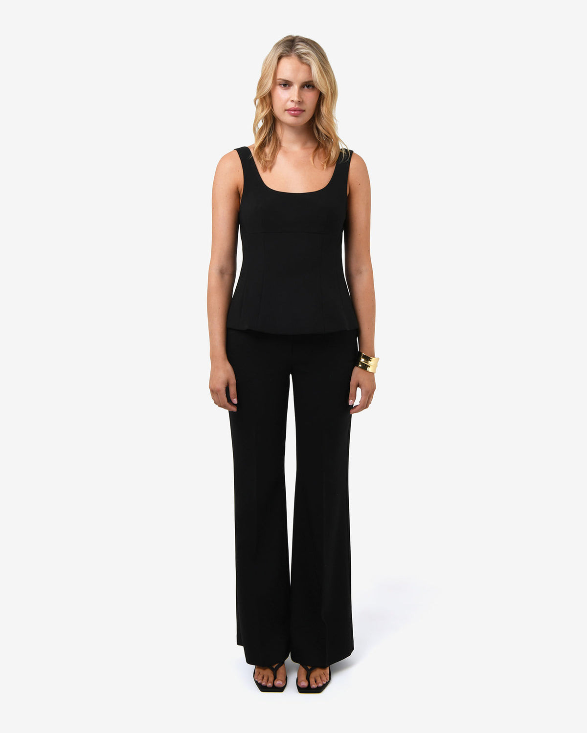 Nikki Peplum Top in black — full-length view