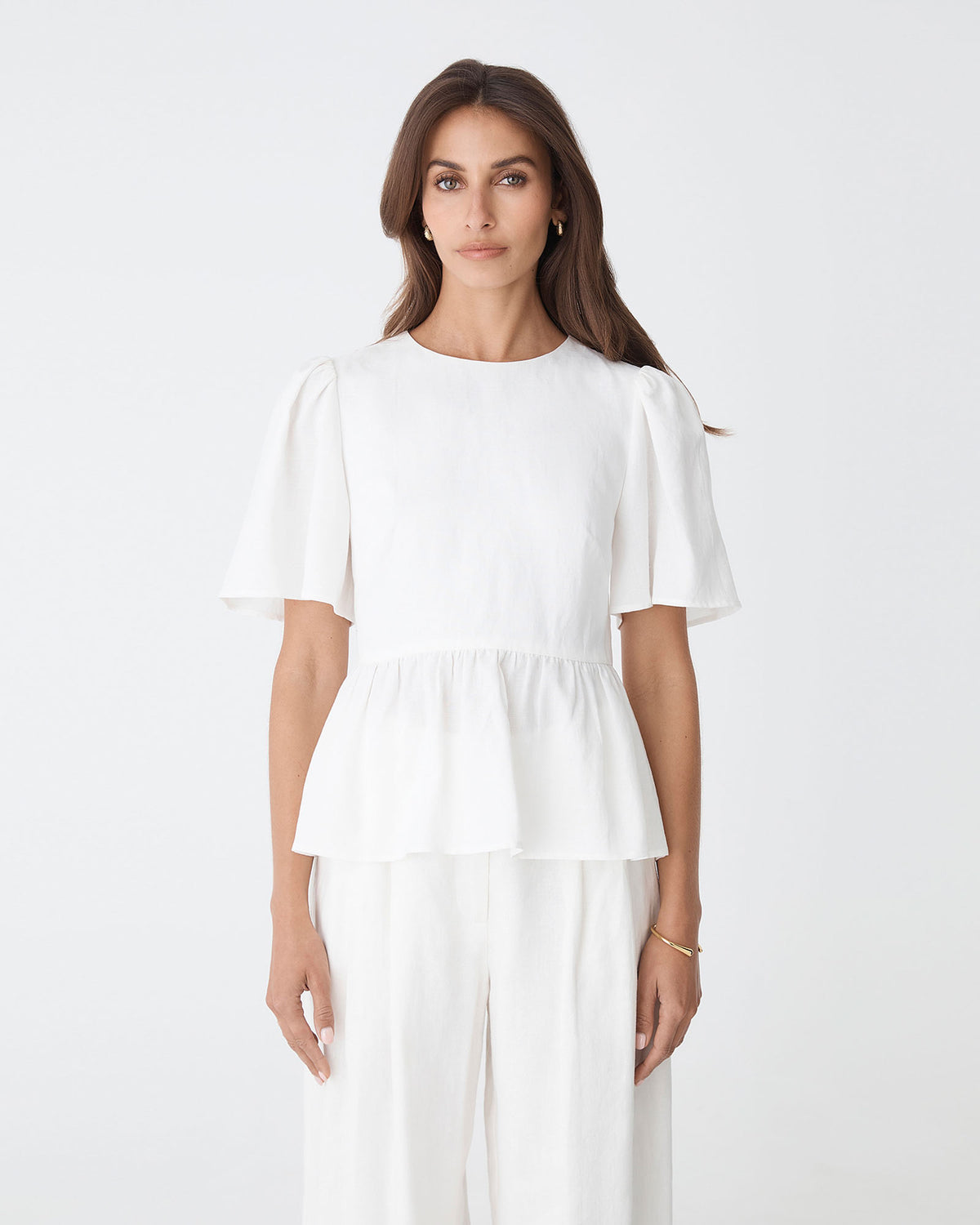 Jade Linen Peplum Top in ivory — close-up view 2