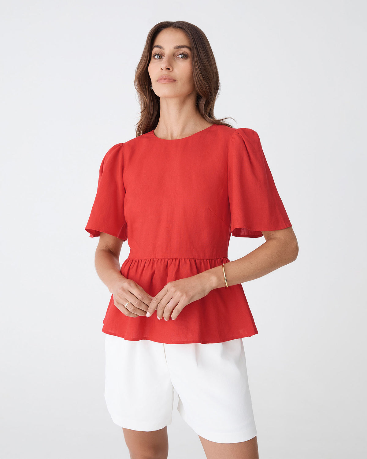 Jade Linen Peplum Top in red — close-up view