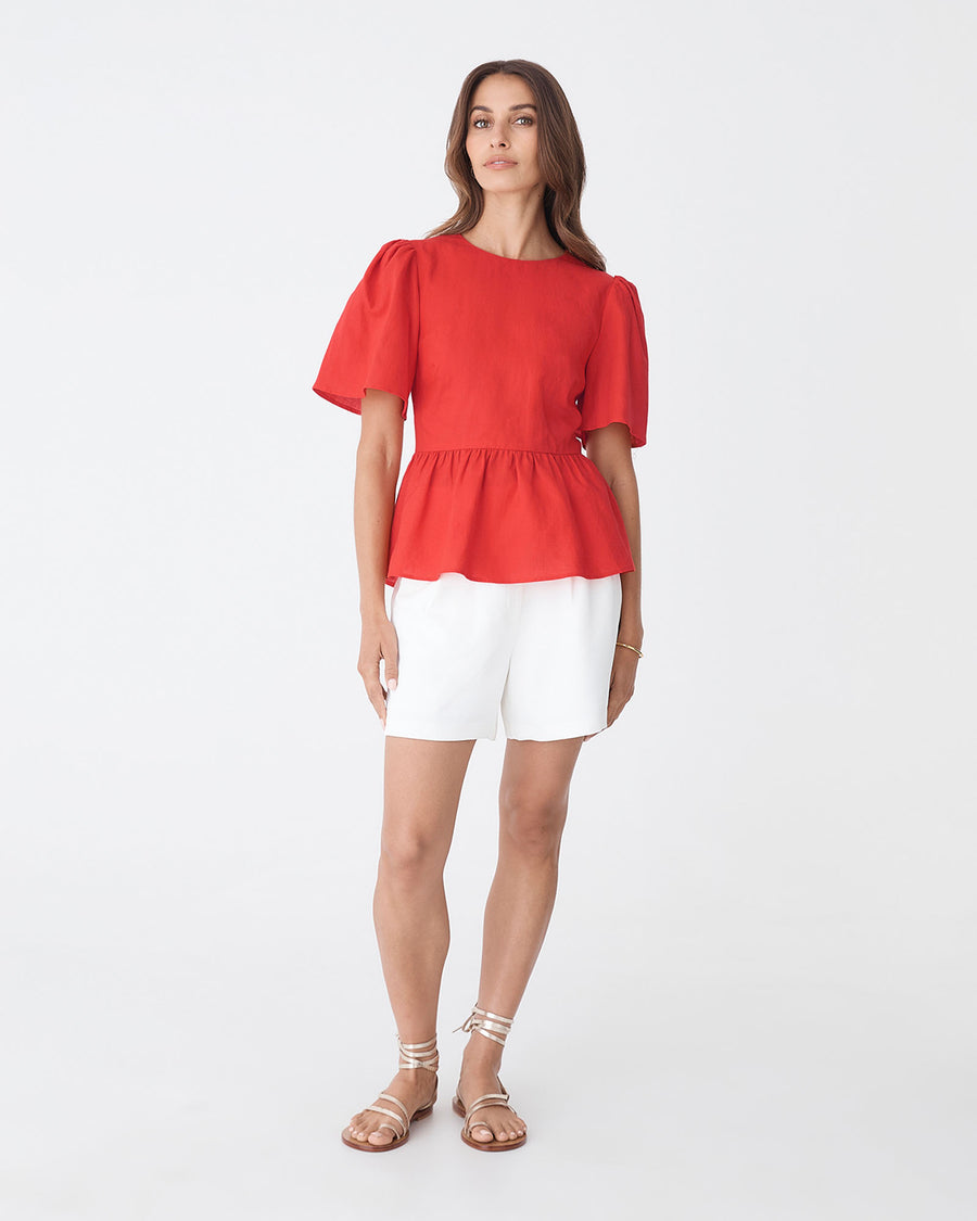 Jade Linen Peplum Top in red — full-length view