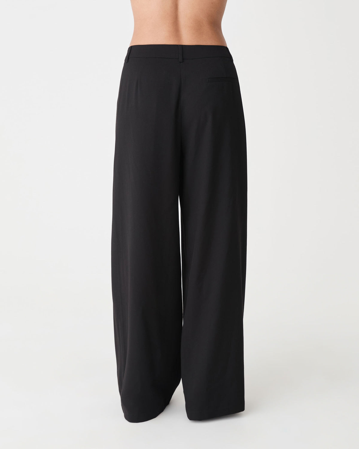 Arden Mid Rise Pleated Pants in black — back view