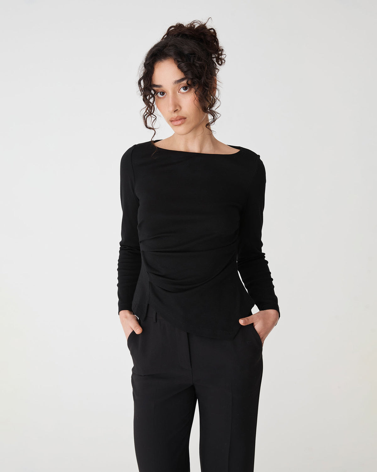 Calia Asymmetric Knit Top in black — close-up view
