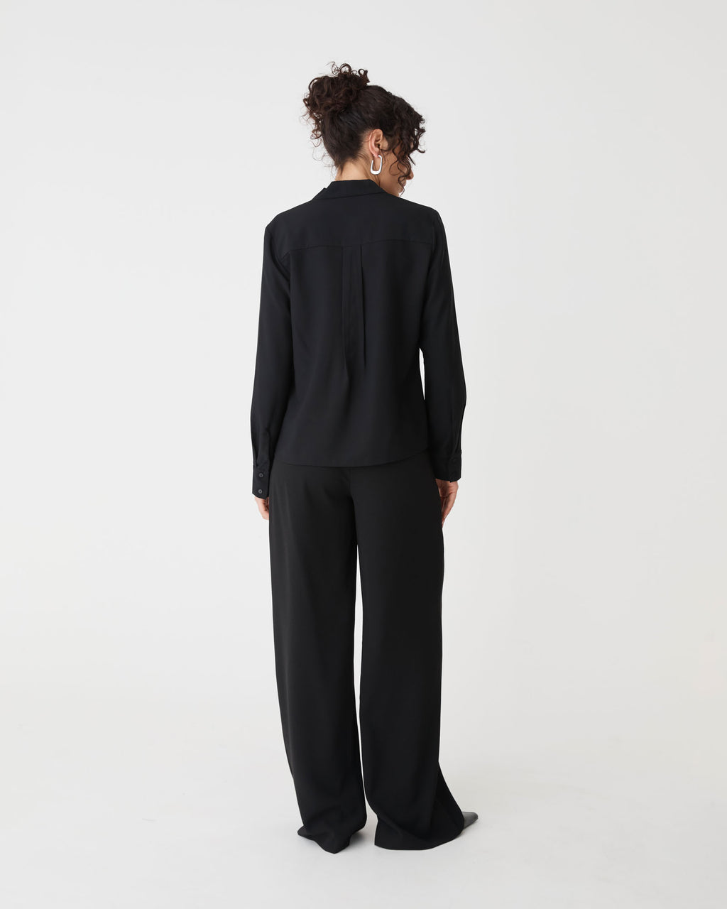 Claudia Pleat Neck Blouse in black — back view