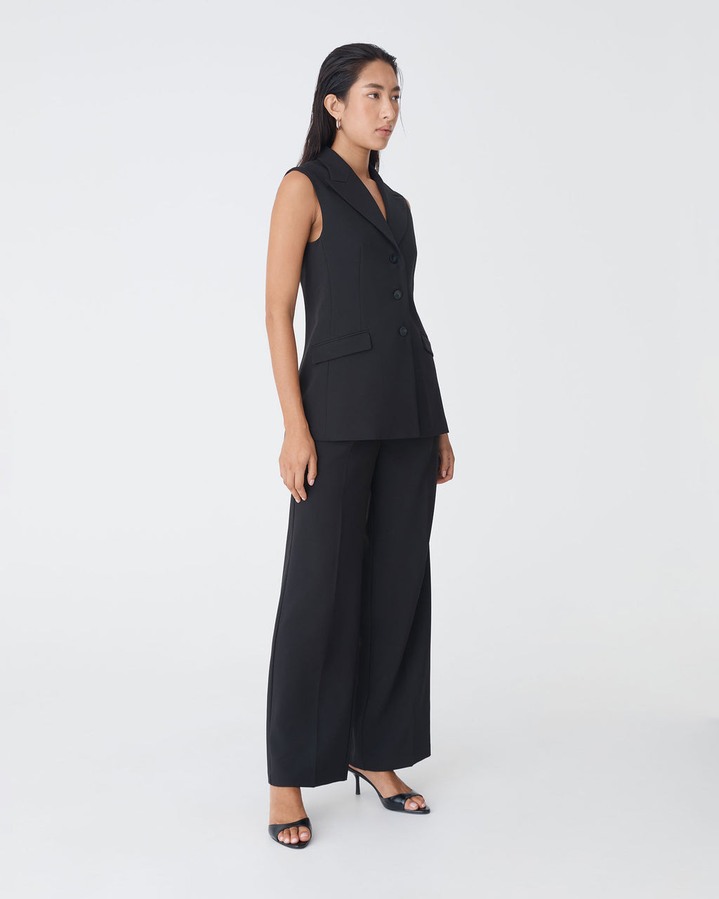 Nikki Long Collared Vest in black — side view