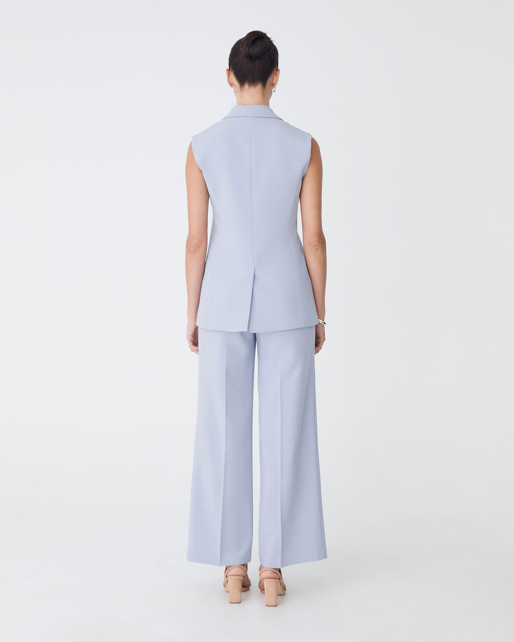 Nikki Long Collared Vest in dusk blue — back view
