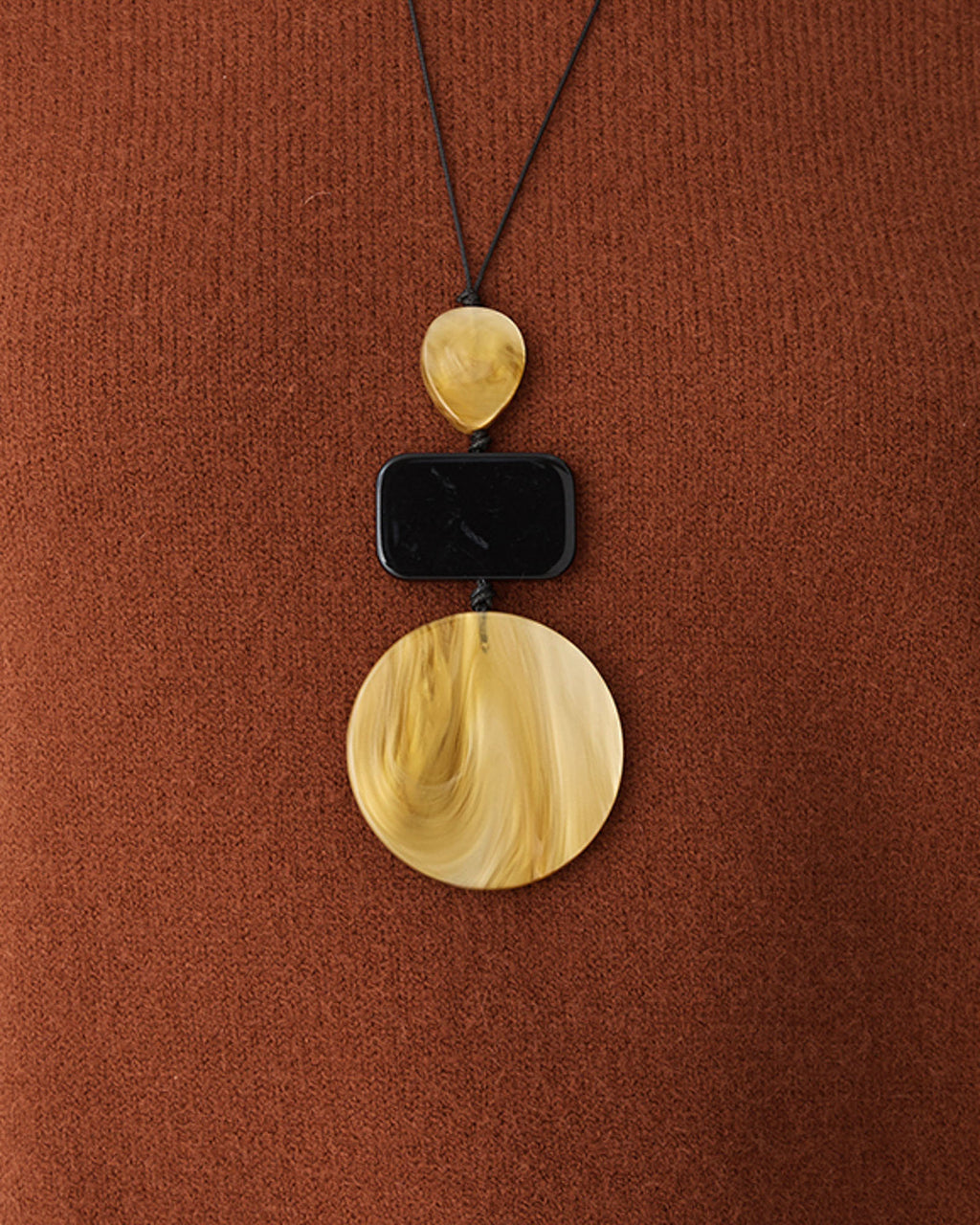 Iris Resin Pendant in marbled amber — fabric detail