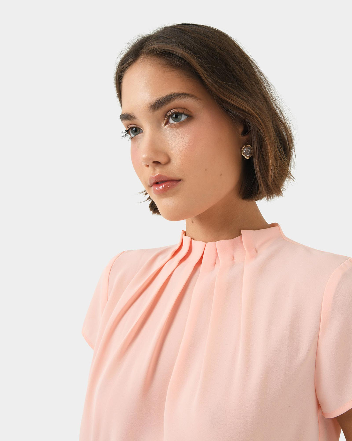 Olivia Pleated High Neck Top in pastel peach — fabric detail